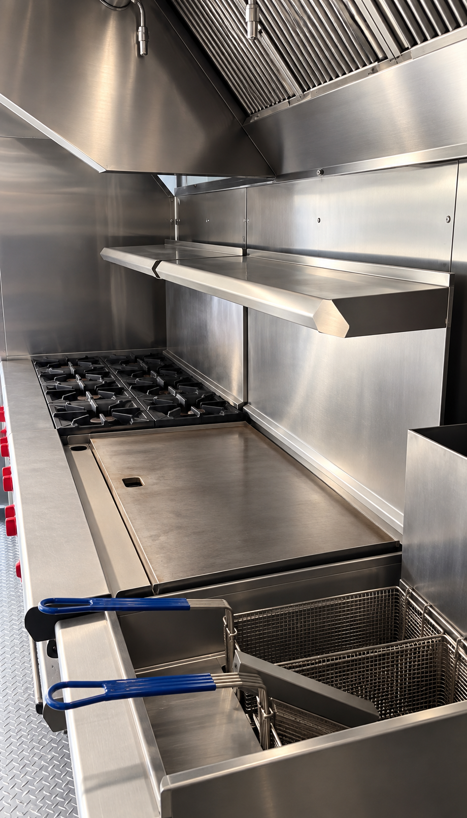 Griddle, range and fryer inside a 40 ft commercial kitchen trailer